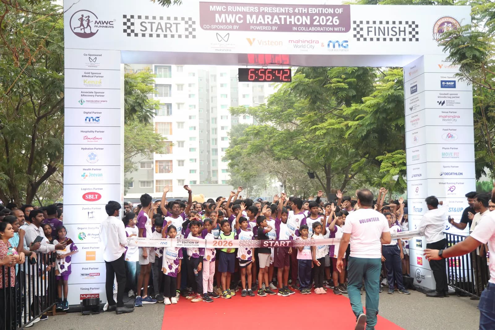 A runner gets a high-five on the road during the MWC Marathon